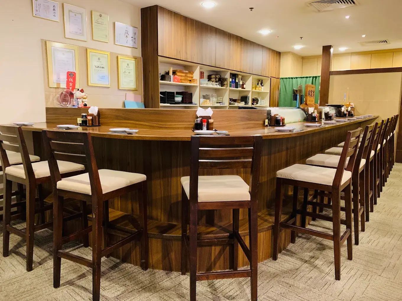 The sushi counter at Yamagawa, seating for guests along the wooden bar